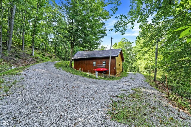 view of side of home featuring an outbuilding