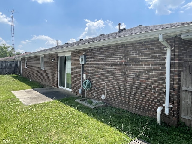 back of house featuring a patio and a lawn