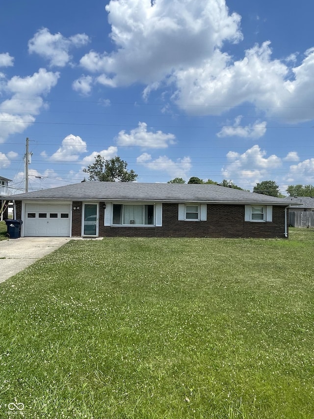 ranch-style home with a front lawn and a garage