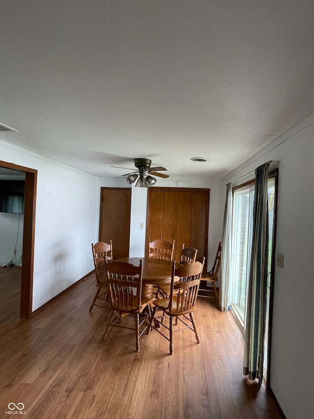 dining space featuring ceiling fan and wood-type flooring