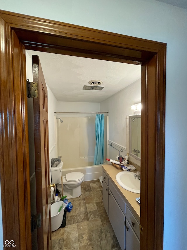 full bathroom featuring vanity, shower / tub combo, and toilet