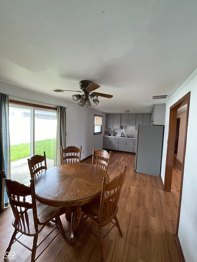 dining room featuring ceiling fan and hardwood / wood-style flooring