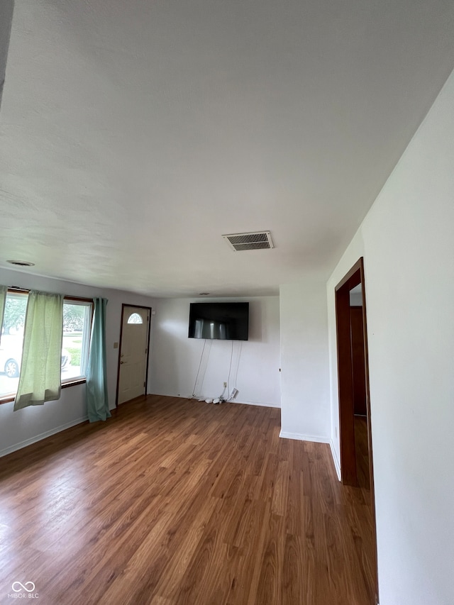 unfurnished living room with hardwood / wood-style flooring