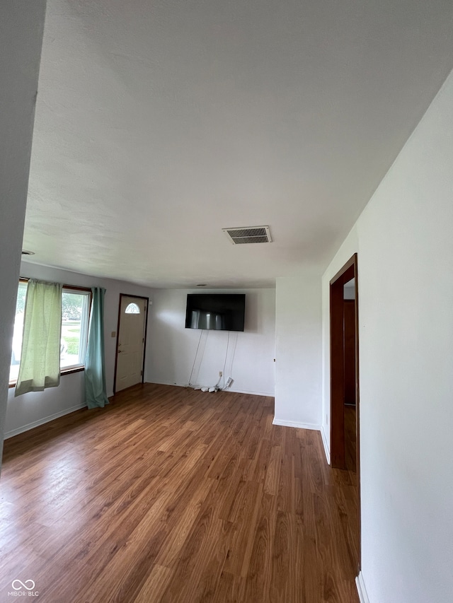 unfurnished living room with hardwood / wood-style floors