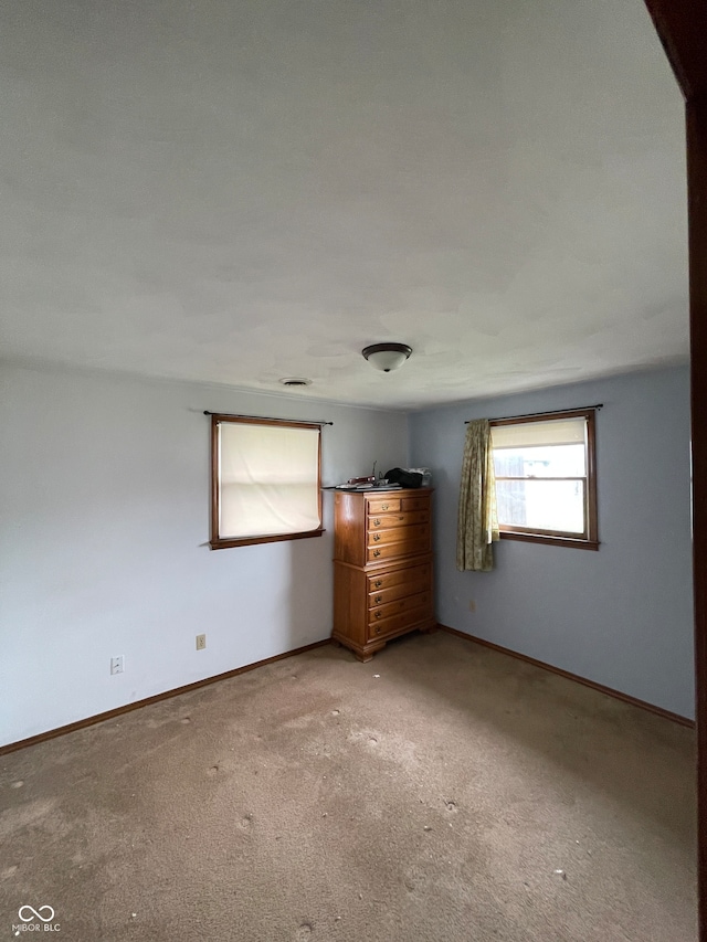 unfurnished bedroom with light colored carpet