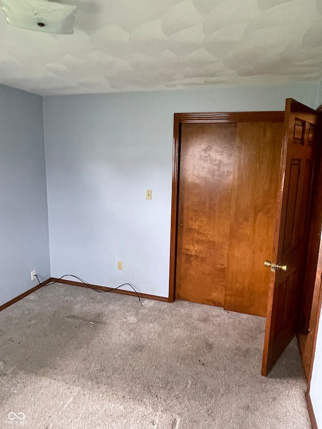 empty room featuring light colored carpet