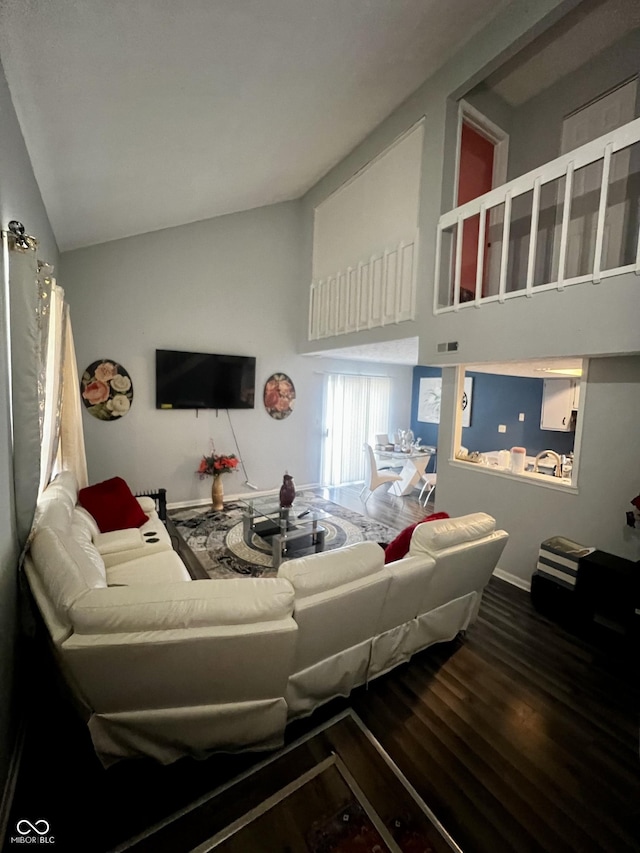 living room with hardwood / wood-style floors and vaulted ceiling