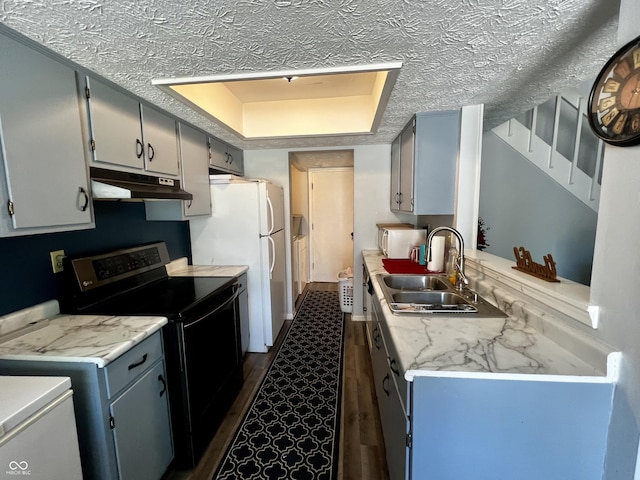 kitchen featuring dark wood-type flooring, electric stove, sink, a textured ceiling, and white fridge