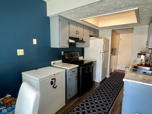 kitchen with electric range, sink, dark hardwood / wood-style flooring, white refrigerator, and fridge