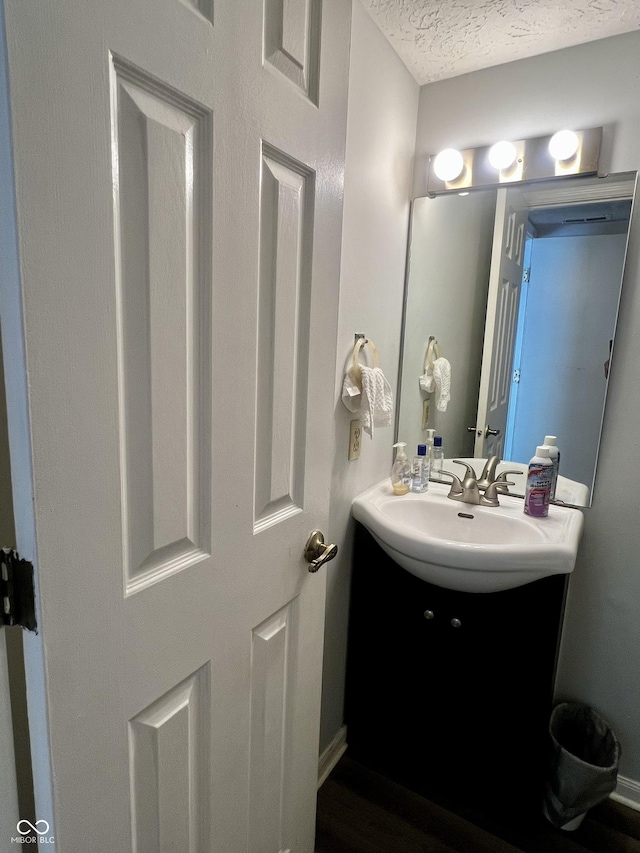 bathroom featuring vanity and a textured ceiling