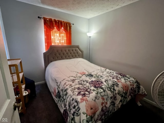 carpeted bedroom featuring a textured ceiling