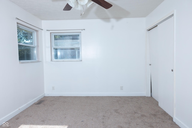 spare room featuring ceiling fan and light colored carpet