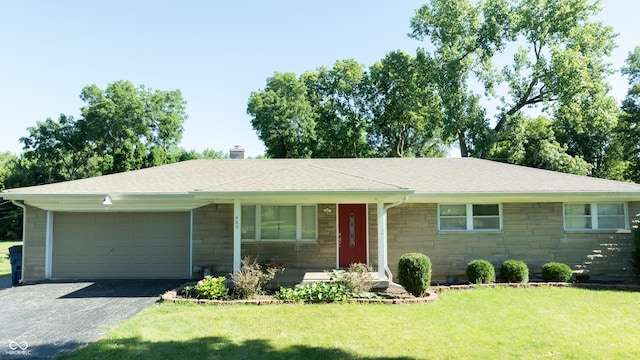 ranch-style home with a garage and a front lawn