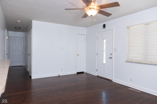 entrance foyer featuring ceiling fan and dark wood-type flooring