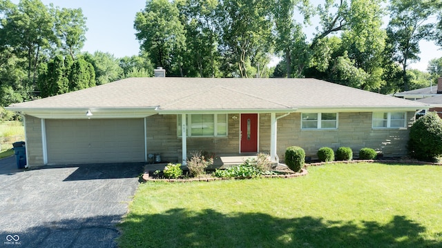 single story home featuring a front lawn and a garage