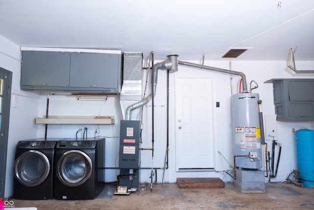 washroom featuring cabinets, washer and clothes dryer, and gas water heater