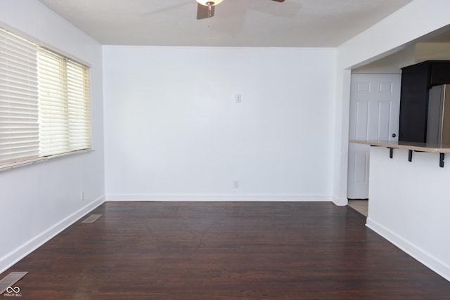 spare room featuring ceiling fan and dark hardwood / wood-style flooring