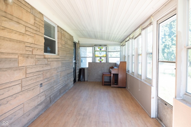 unfurnished sunroom with lofted ceiling