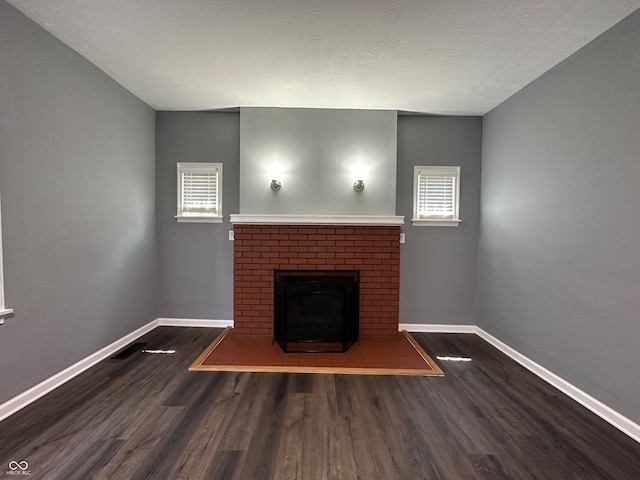 unfurnished living room with dark hardwood / wood-style floors and a fireplace