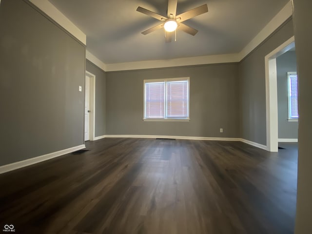 spare room with dark hardwood / wood-style flooring and ceiling fan