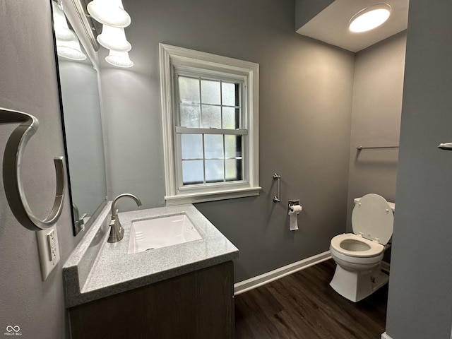 bathroom featuring vanity, hardwood / wood-style floors, and toilet