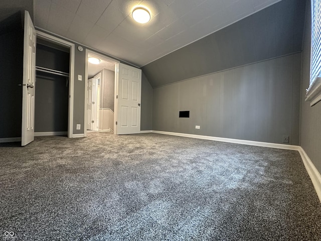 bonus room featuring vaulted ceiling and carpet