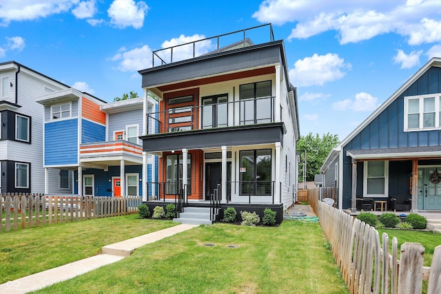 1218 Orange St, Indianapolis, IN 46203 - contemporary home with a balcony, covered porch, and board and batten siding