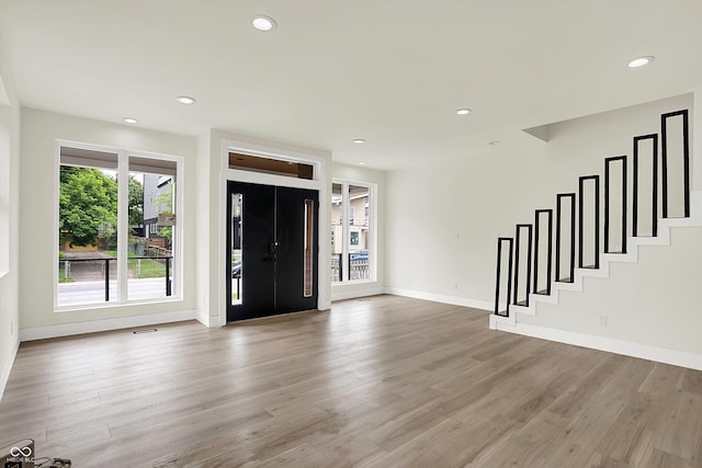1218 Orange St, Indianapolis, IN 46203 - entryway featuring light wood-style floors, baseboards, recessed lighting, and stairway