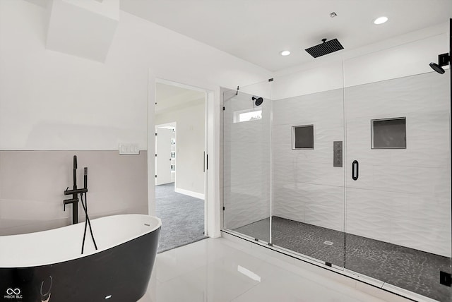 1218 Orange St, Indianapolis, IN 46203 - bathroom with a shower stall, a freestanding bath, recessed lighting, baseboards, and tile patterned flooring