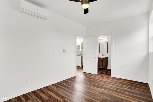 1218 Orange St, Indianapolis, IN 46203 - empty room featuring an AC wall unit, dark wood-style flooring, ceiling fan, a sink, and baseboards