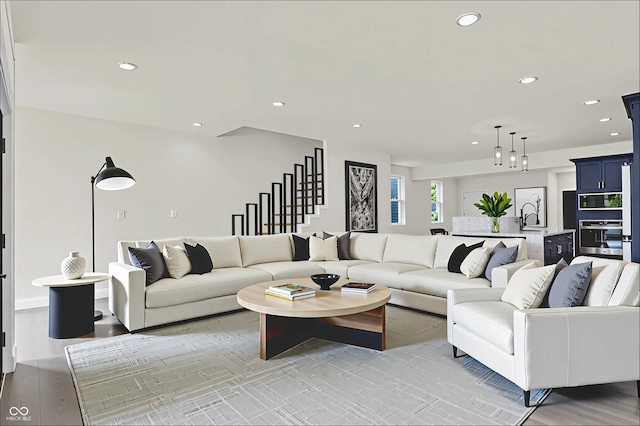 1218 Orange St, Indianapolis, IN 46203 - living room with recessed lighting, stairs, and light wood-style floors