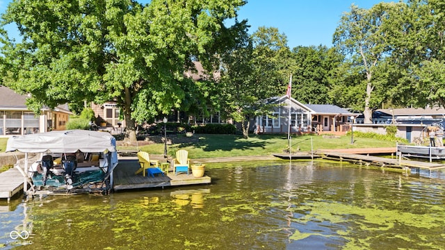 view of dock featuring a water view and a lawn