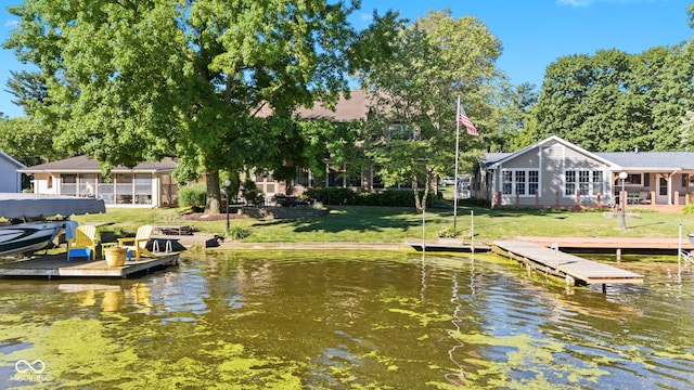 dock area featuring a water view and a yard