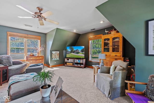 carpeted living room with vaulted ceiling, a healthy amount of sunlight, and ceiling fan