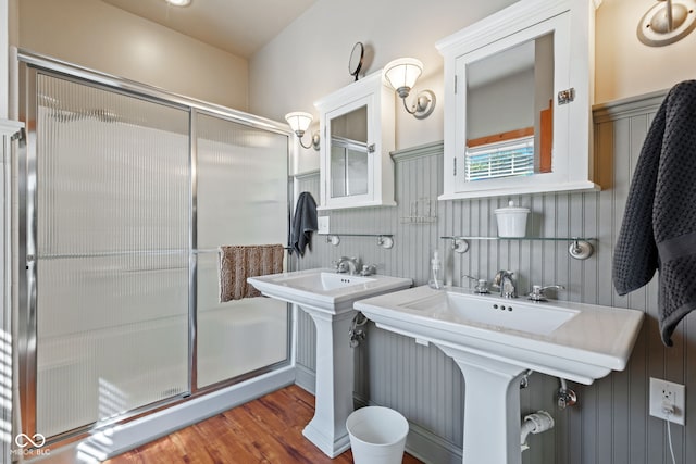 bathroom with an enclosed shower, hardwood / wood-style flooring, and double sink