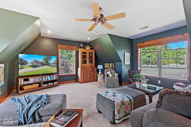 living room featuring lofted ceiling, ceiling fan, and carpet