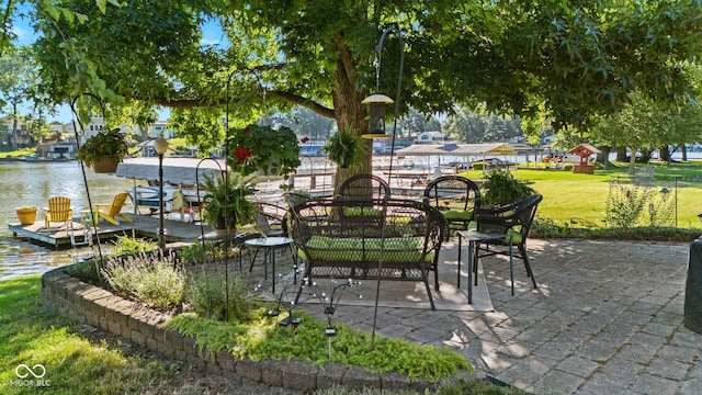 view of patio / terrace with a boat dock and a water view