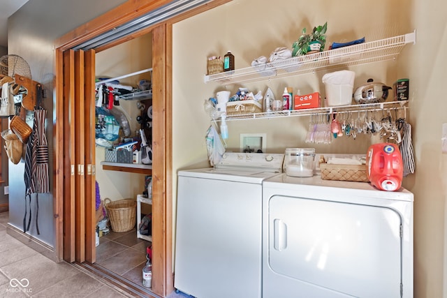 clothes washing area with separate washer and dryer and tile patterned floors