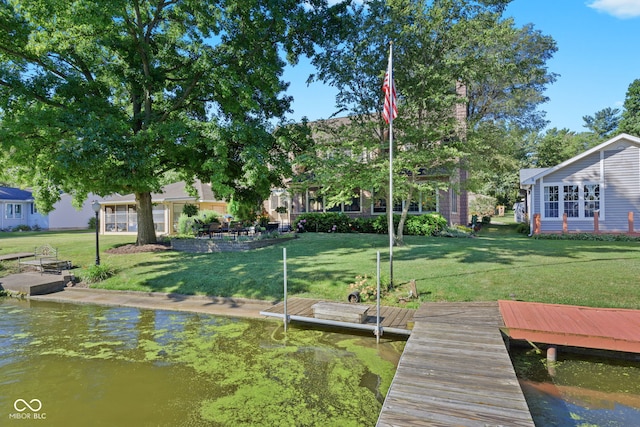 dock area featuring a lawn and a water view