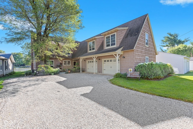 view of front of house with a garage and a front lawn