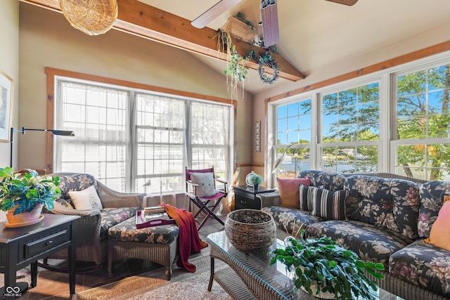 sunroom with ceiling fan and vaulted ceiling with beams