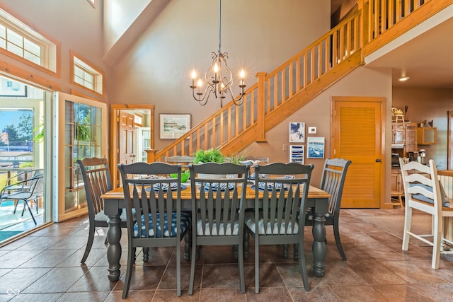 dining area with a notable chandelier and a high ceiling