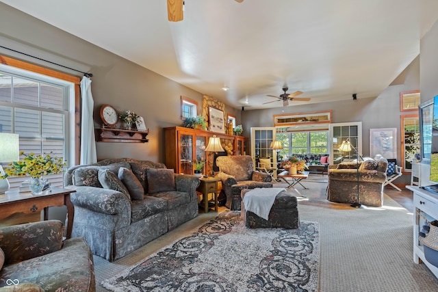 carpeted living room with ceiling fan