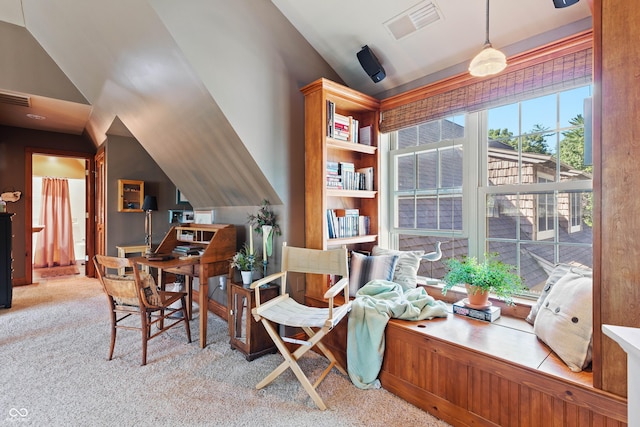 sitting room featuring lofted ceiling and light carpet