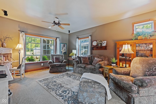 carpeted living room with a healthy amount of sunlight and ceiling fan