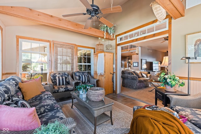 tiled living room with ceiling fan and beamed ceiling