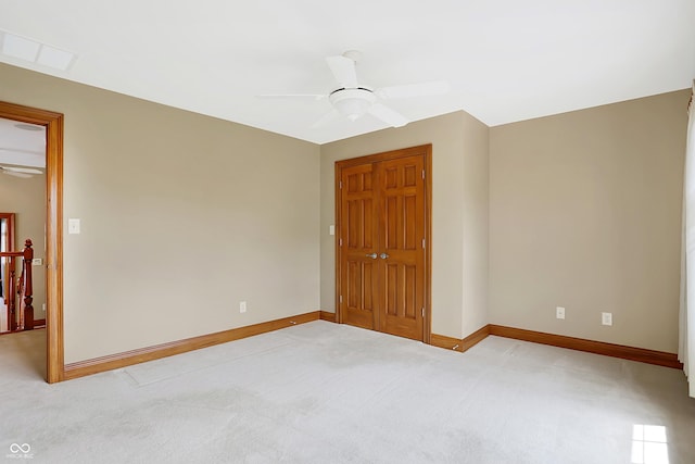 unfurnished room featuring ceiling fan and light colored carpet