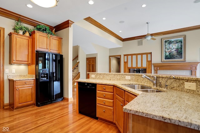 kitchen featuring ceiling fan, sink, ornamental molding, black appliances, and light wood-type flooring