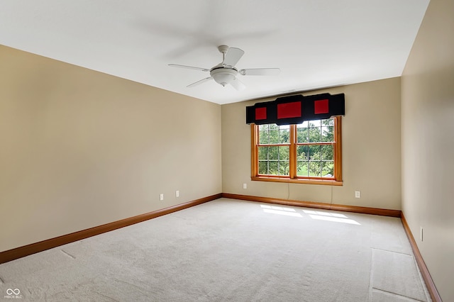 carpeted spare room featuring ceiling fan