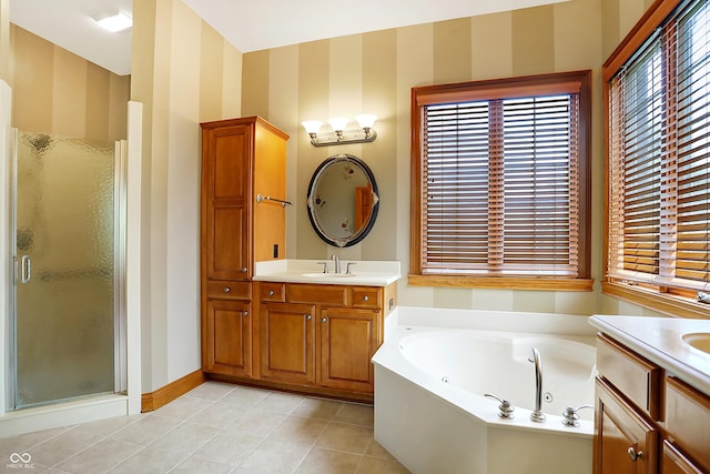 bathroom with tile patterned flooring, vanity, and independent shower and bath